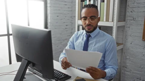 Young man with braids reviewing document... | Stock Video | Pond5