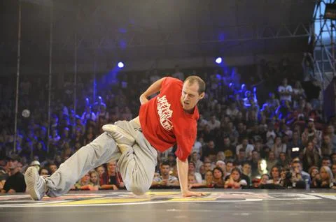 Young man break dancer performing on stage during breakdance battle. Break da Stock Photos