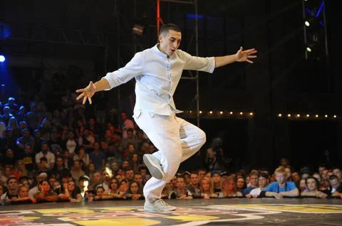 Young man break dancer performing on stage during breakdance battle. Break da Stock Photos