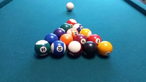 A young man breaks billiard balls. The game of billiards, breaking balls Stock Footage 171665958