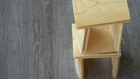 A young man breaks a small house of boards Stock Footage 76634030