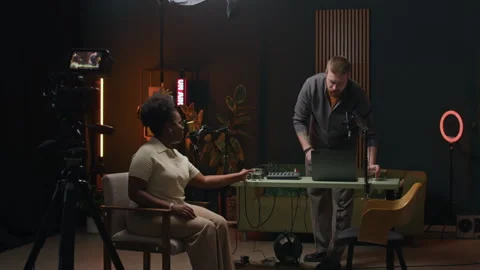 Young Man Bringing Water to Black Woman before Starting Podcast Stock Footage 294689998