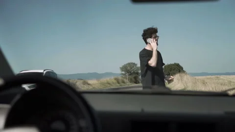 Young Man With A Broken Car Calling For Help Video stock 132905032
