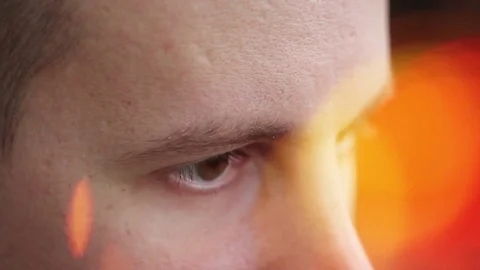 A young man with brown eyes looking to the side ,a computer effect Video stock 75459697