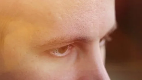 A young man with brown eyes looking to the side ,a computer effect Video stock 75459804