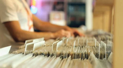 A Young man browses through a selection of vintage records Stockbeeldmateriaal 40634398