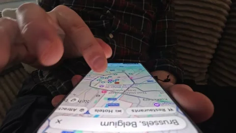 Young Man Browsing Brussels Streets On A Map In Google Maps App On Smartphone Stock Footage 330537312
