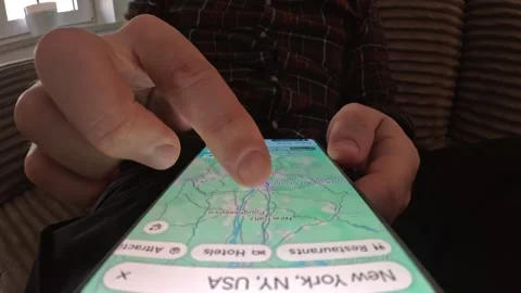 Young Man Browsing Google Map App Looking For New York On A Smartphone Screen Stock Footage 330537188