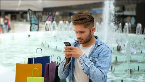 Young man browsing internet , chat sms on smartphone 스톡 동영상 95484308