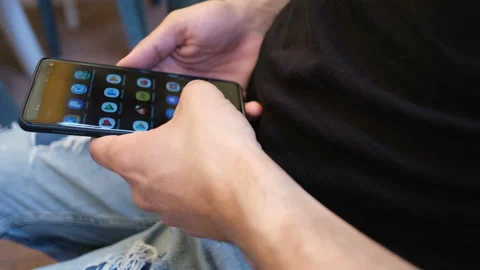Young man browsing on smartphone apps,hi tech device,social networking,web Stock Footage 136964960