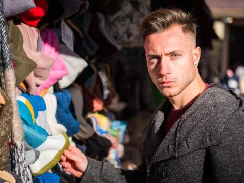 Young man browsing through products in open air market Stock Photos
