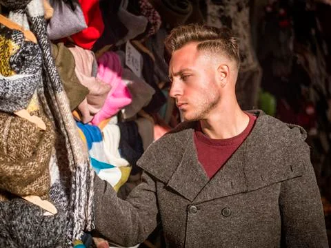 Young man browsing through products in open air market Stock Photos