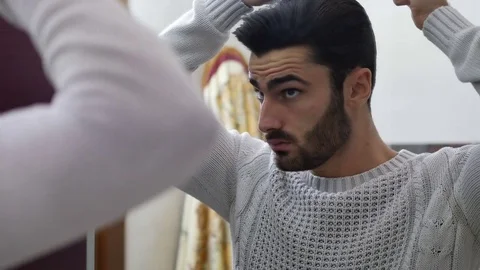 Young Man Brushing and Combing Hair in Mirror Stock Footage 84497400
