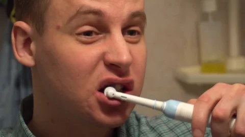 Young man brushing his teeth in the morning Video stock 75002214