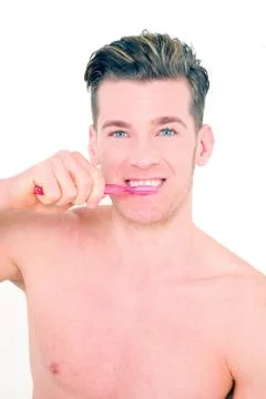 Young man brushing his teeth Stock Photos