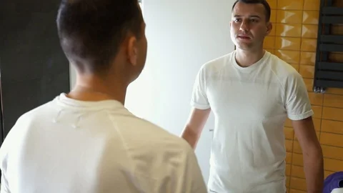 Young Man Brushing Teeth In Bathroom in front of mirror. Doing hygiene routine Stock Footage 121003168