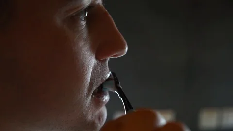 Young Man Brushing Teeth In Bathroom in front of mirror. Doing hygiene routine Stock Footage 124879156