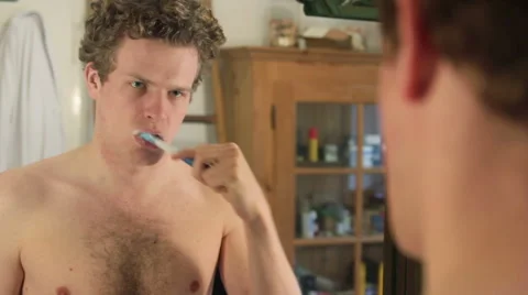 Young man brushing teeth Stock Footage 40844011