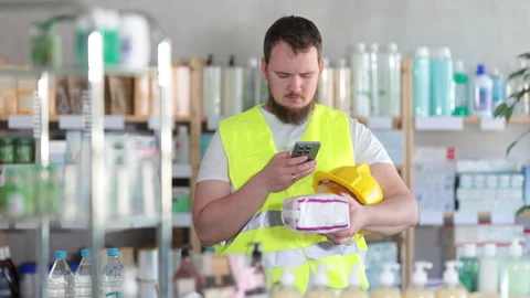 Young man builder scanning qr code of feminine pads Stock Footage 312230149