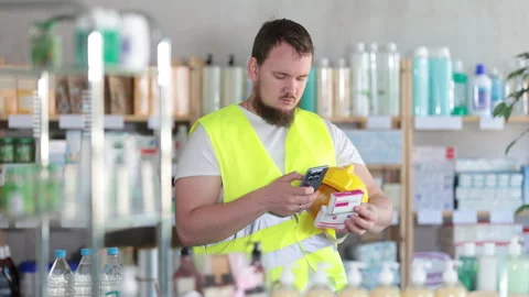 Young man builder scanning qr code of paracetamol Stock Footage 321338416