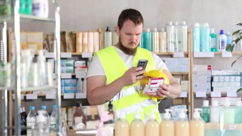 Young man builder scanning qr code of paracetamol Stock Footage 329540883