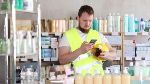 Young man builder scanning qr code of syrup Stock Footage 330039502