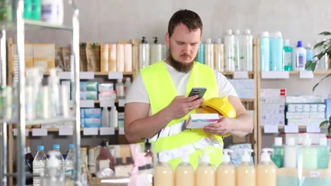 Young man builder scanning qr code of pills Stock Footage 343133003