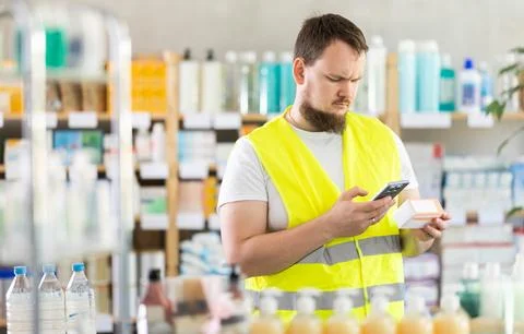 Young man builder scanning qr code of pills Stock-Fotos