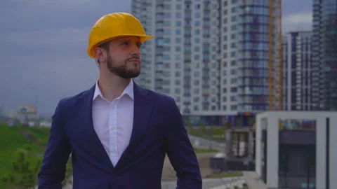 Young man builder smiling on building background. Close-up portrait of a man. a Stock Footage 89694575