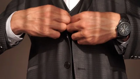 Young man buttoning buttons in his jacket. Young businessman Stock Footage 127433537