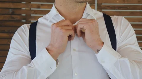 Young man buttoning a cuff. Stock Footage 107990271