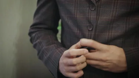 Young man buttoning jacket Stock Footage 46353947