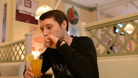 A young man in a cafe drinking lemonade Stock-Footage 88831388