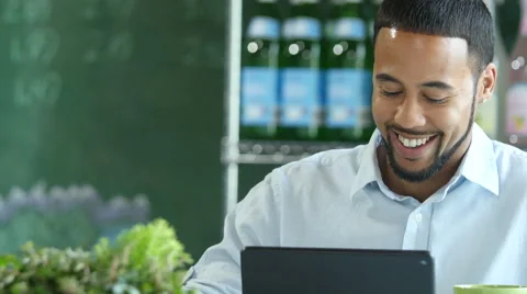Young man in a cafe setting using an ipad/tablet Stock Footage 52332053