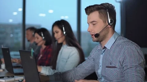 Young man in call center Stock Footage