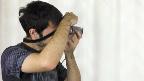 A young man with a camera in his hands. Photographer. Stock Footage 100187352