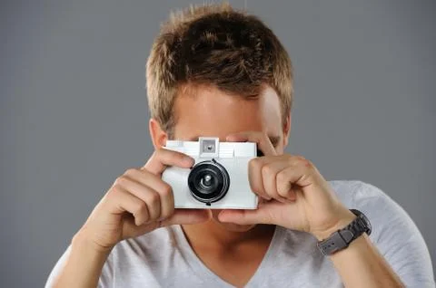 Young man with a camera Stock Photos