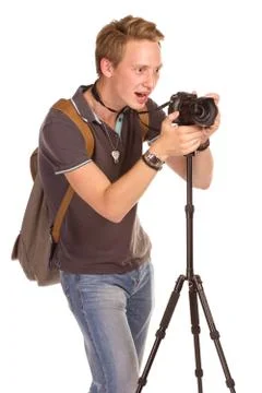 Young man with camera on tripod Stock-Fotos