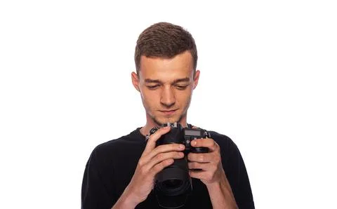 Young man with a camera on a white background. Stock Photos