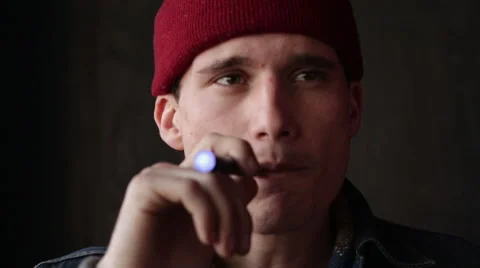 Young Man in Cap Vapes Smokes an E-Cigarette Full Face Frontal Stock Footage 46062154