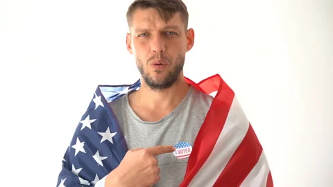 A young man with a cape, I vote on his chest and with a flag calls to come to Stock Footage 140729233