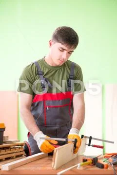 Young man carpenter working in workshop Stock Photos
