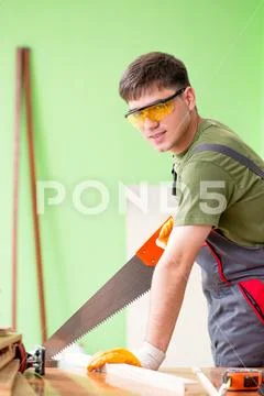 Young man carpenter working in workshop Stock Photos