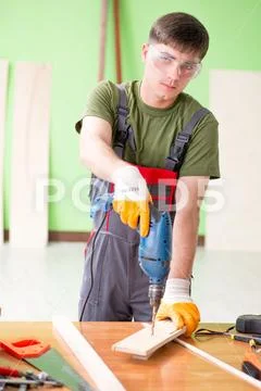 Young man carpenter working in workshop Stock Photos