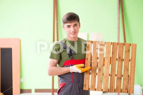 Young man carpenter working in workshop Stock Photos