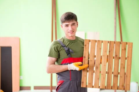 Young man carpenter working in workshop Stock-Fotos
