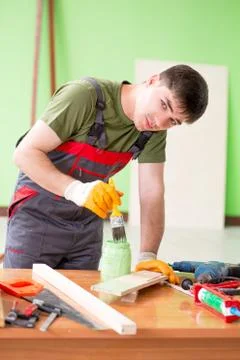 Young man carpenter working in workshop Fotos Stock