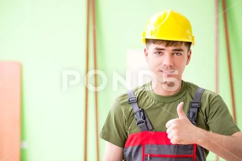 Young man carpenter working in workshop Stock Photos