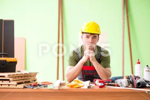Young man carpenter working in workshop Stock Photos