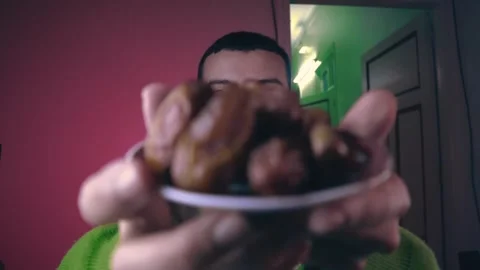 A young man carrying dates in preparation for breaking the fast during Ramadan Video stock 299574446
